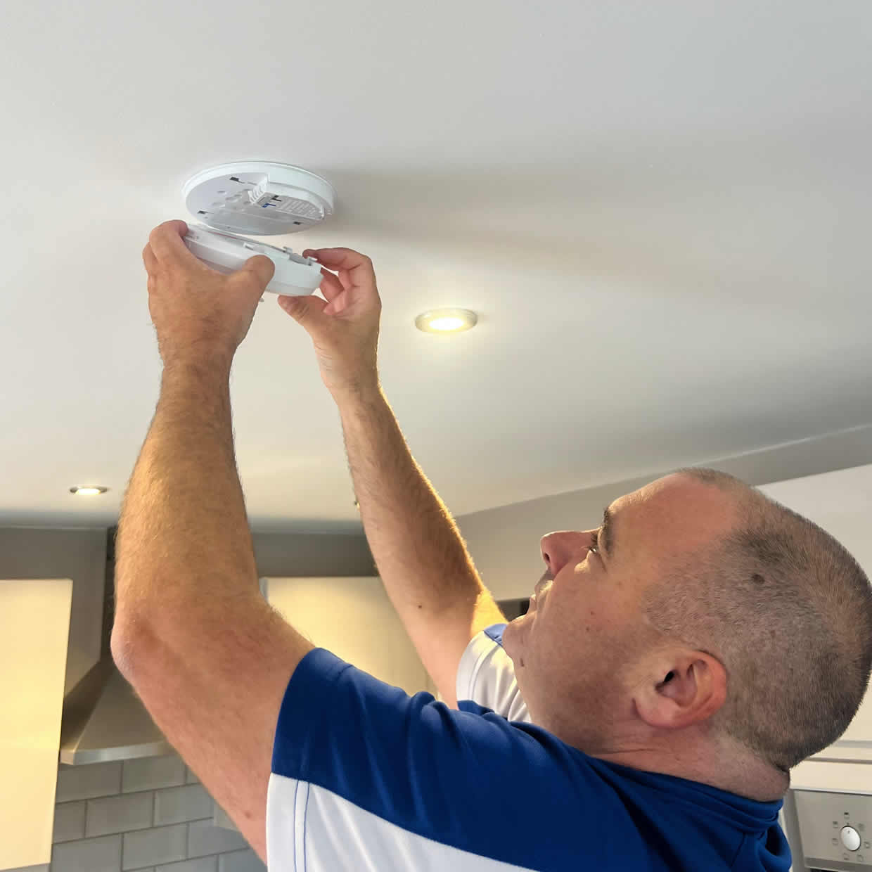 Smoke alarm being installed on a ceiling in Tamworth